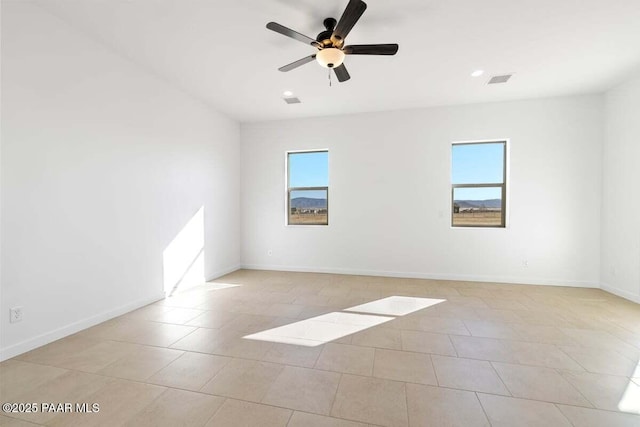 unfurnished room featuring plenty of natural light, visible vents, baseboards, and a ceiling fan