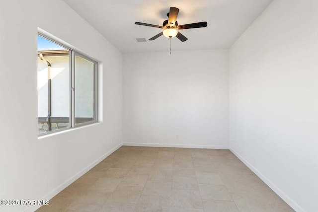 unfurnished room featuring visible vents, baseboards, and a ceiling fan