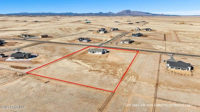 aerial view with a mountain view, a rural view, and view of desert