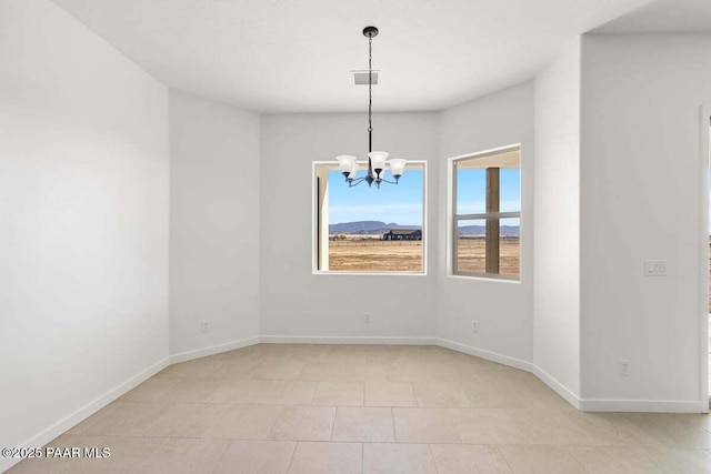 spare room featuring visible vents, baseboards, and a notable chandelier