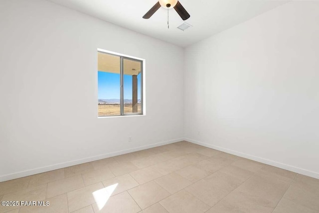 spare room with visible vents, baseboards, and ceiling fan