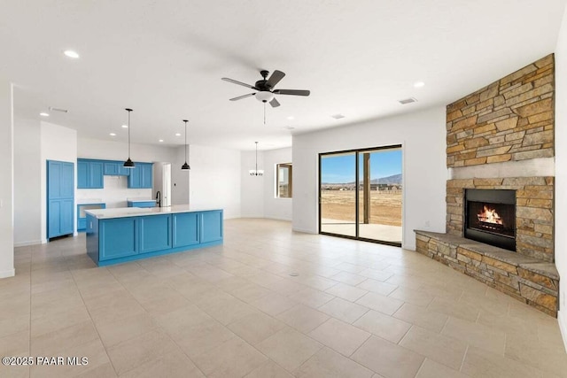 unfurnished living room with visible vents, a ceiling fan, recessed lighting, a fireplace, and baseboards