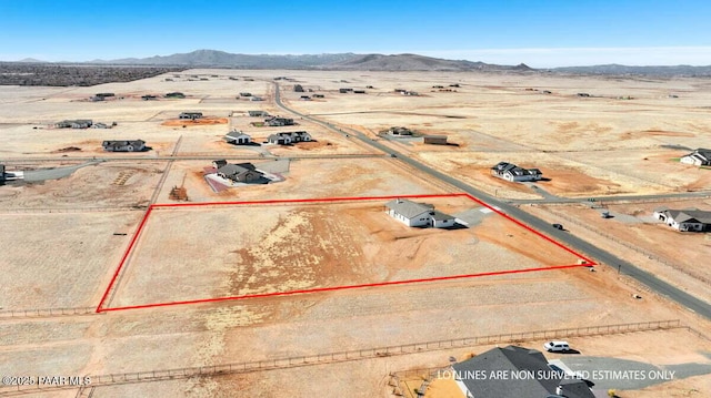 birds eye view of property featuring a mountain view, a desert view, and a rural view