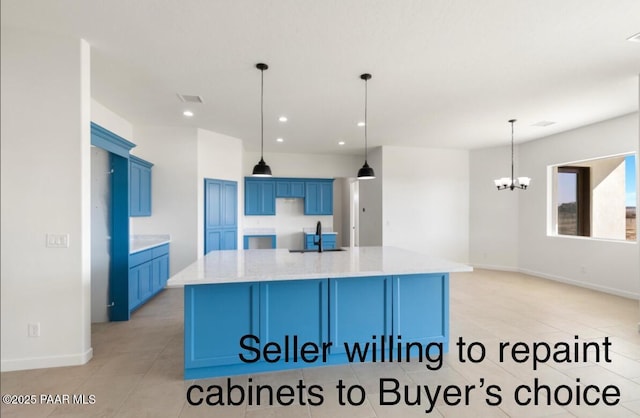 kitchen with a chandelier, recessed lighting, blue cabinetry, and a large island with sink