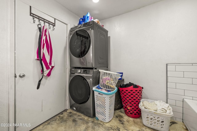 washroom with stacked washing maching and dryer