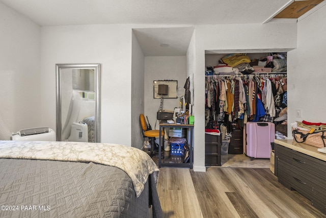 bedroom with hardwood / wood-style flooring and a closet