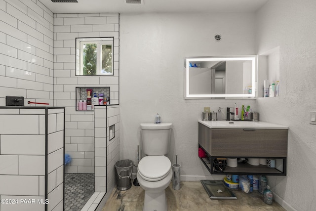 bathroom with toilet, wood-type flooring, sink, and a tile shower