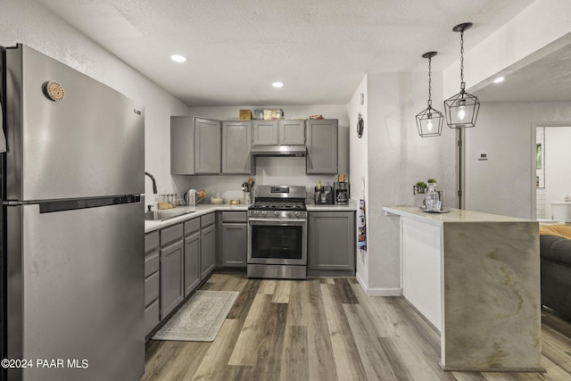 kitchen featuring gray cabinets, sink, stainless steel appliances, and hardwood / wood-style flooring