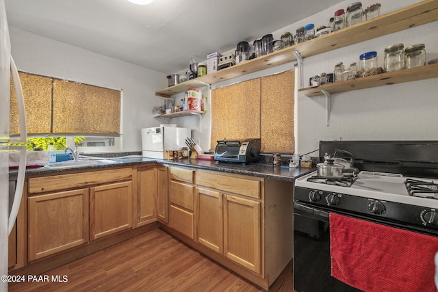 kitchen with gas stove, sink, and light hardwood / wood-style floors