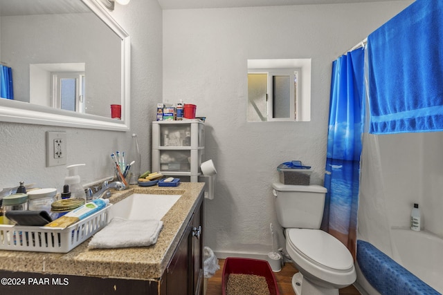 full bathroom with vanity, hardwood / wood-style flooring, toilet, and shower / bathtub combination with curtain