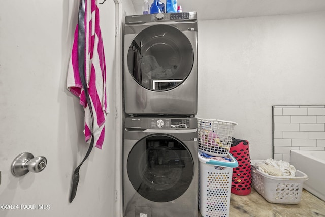 washroom featuring stacked washer / dryer