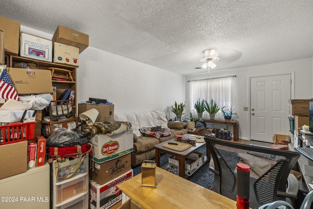 misc room with ceiling fan and a textured ceiling