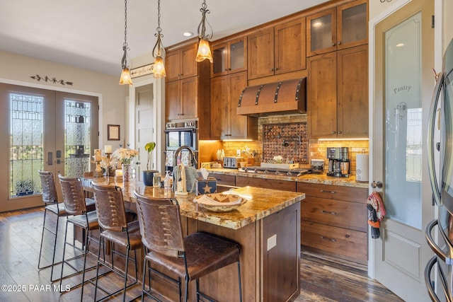 965 Northwood Loop, Prescott, AZ 86303 - kitchen with brown cabinetry, appliances with stainless steel finishes, custom exhaust hood, dark wood-type flooring, and recessed lighting