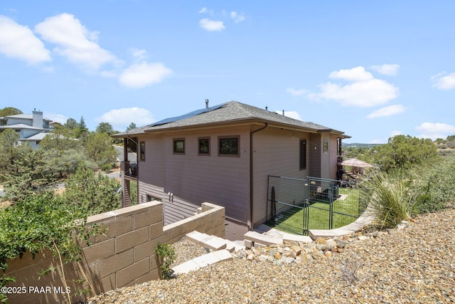 965 Northwood Loop, Prescott, AZ 86303 - view of side of home featuring solar panels, a gate, and a shingled roof