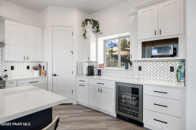1232 Jordin Dr, Prescott, AZ 86303 - kitchen featuring tasteful backsplash, white cabinetry, wine cooler, and light hardwood / wood-style flooring