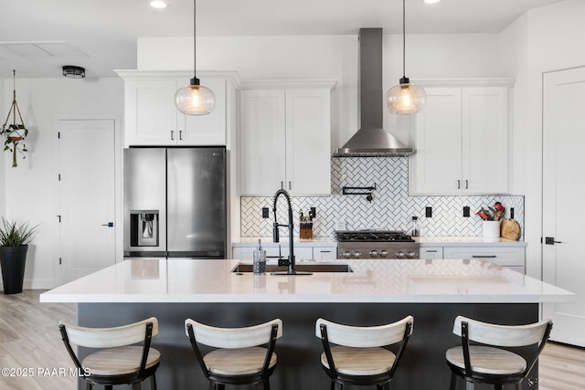 1232 Jordin Dr, Prescott, AZ 86303 - kitchen featuring an island with sink, sink, white cabinets, stainless steel appliances, and wall chimney range hood