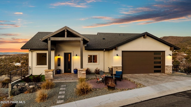 view of front of property with a garage and a fire pit