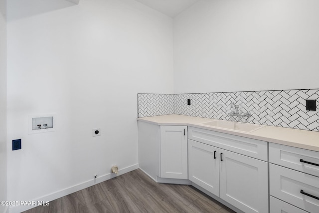 1232 Jordin Dr, Prescott, AZ 86303 - laundry room with sink, cabinets, light hardwood / wood-style flooring, hookup for a washing machine, and hookup for an electric dryer