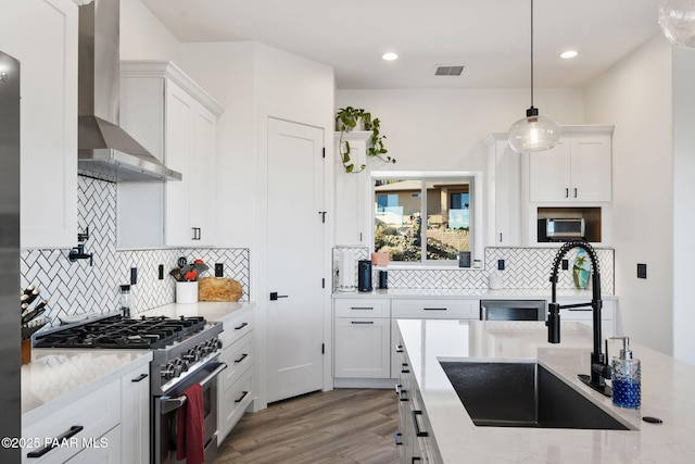 1232 Jordin Dr, Prescott, AZ 86303 - kitchen with wall chimney range hood, sink, stainless steel appliances, white cabinets, and decorative light fixtures