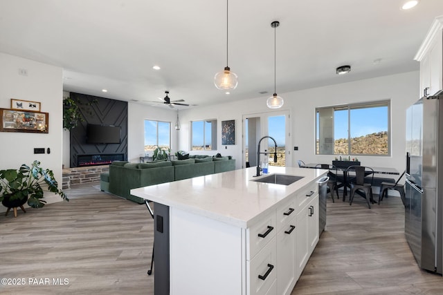 1232 Jordin Dr, Prescott, AZ 86303 - kitchen featuring sink, white cabinetry, decorative light fixtures, stainless steel appliances, and a kitchen island with sink