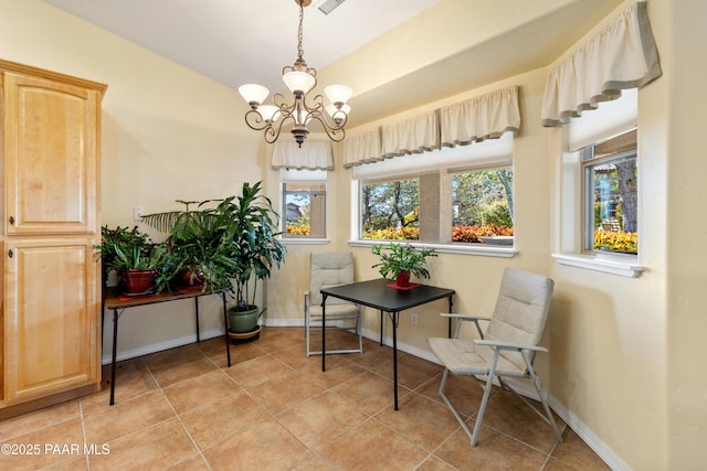 living area with plenty of natural light, baseboards, light tile patterned flooring, and a chandelier