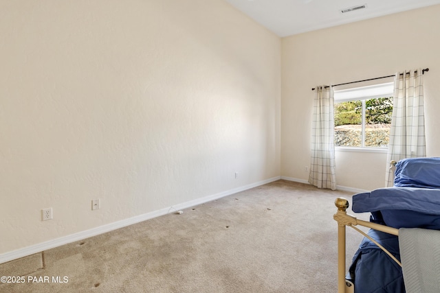 carpeted bedroom with baseboards and visible vents