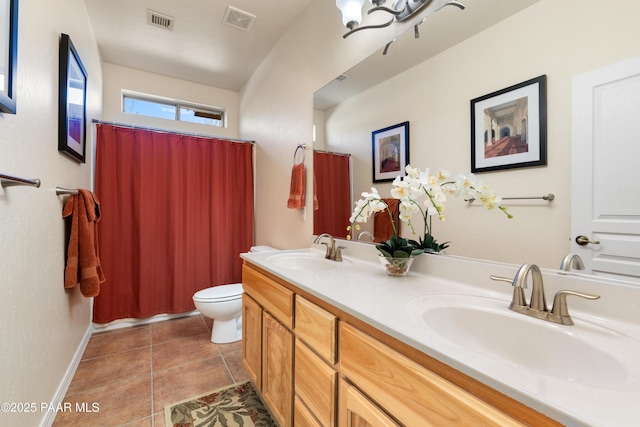 bathroom featuring visible vents, a sink, and toilet