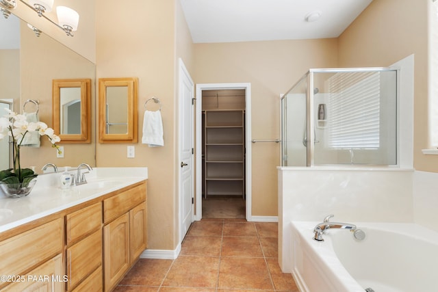 full bathroom with tile patterned flooring, vanity, a shower stall, a spacious closet, and a bath