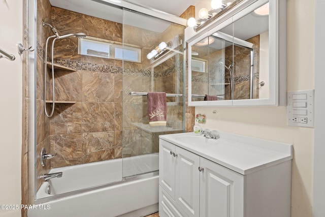 full bathroom featuring combined bath / shower with glass door and vanity