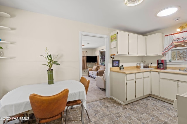kitchen with white cabinetry and light countertops