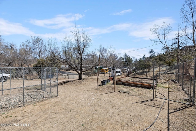 view of yard featuring fence and a vegetable garden