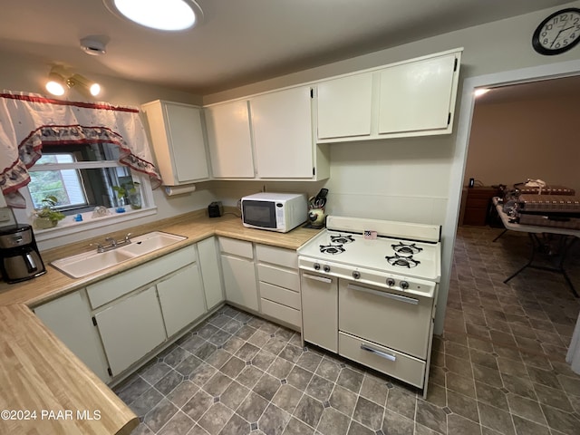 kitchen featuring white cabinets, white appliances, and sink