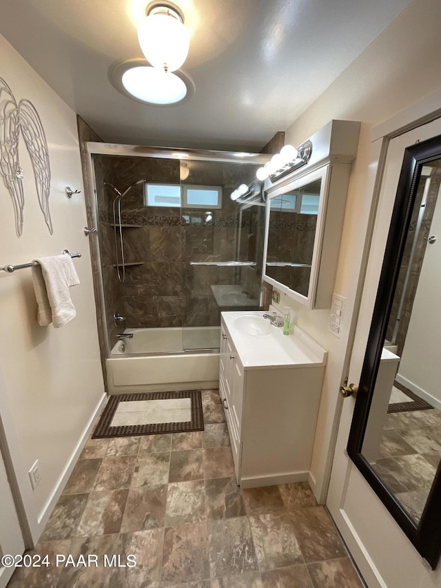 bathroom featuring vanity and bath / shower combo with glass door