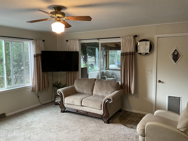 carpeted living room with ceiling fan