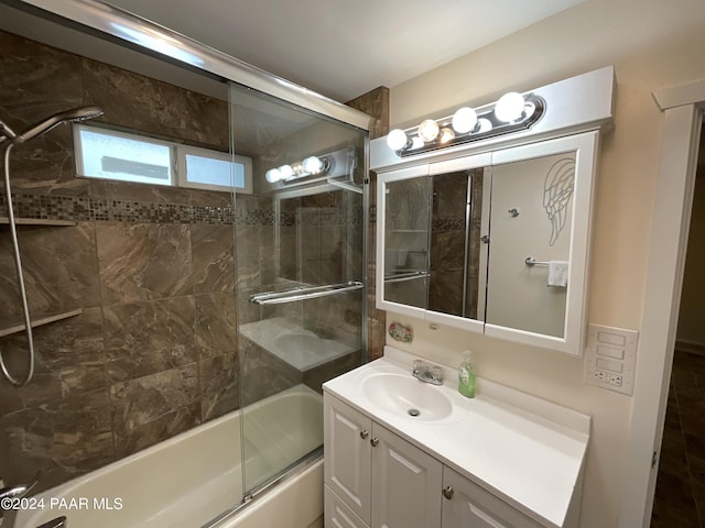 bathroom with vanity and enclosed tub / shower combo