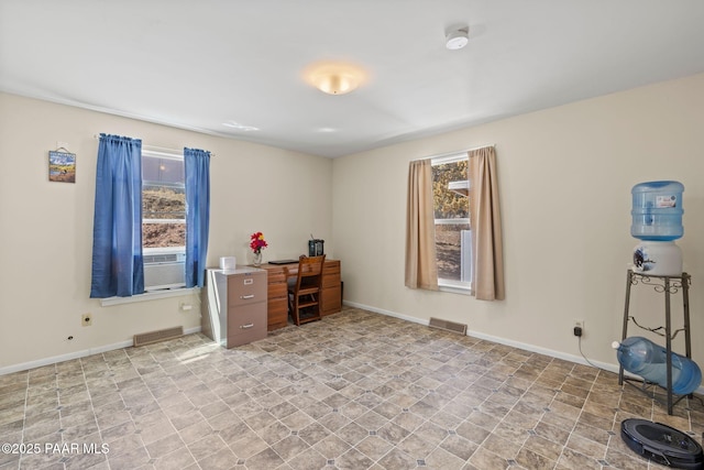 interior space featuring baseboards, visible vents, and cooling unit
