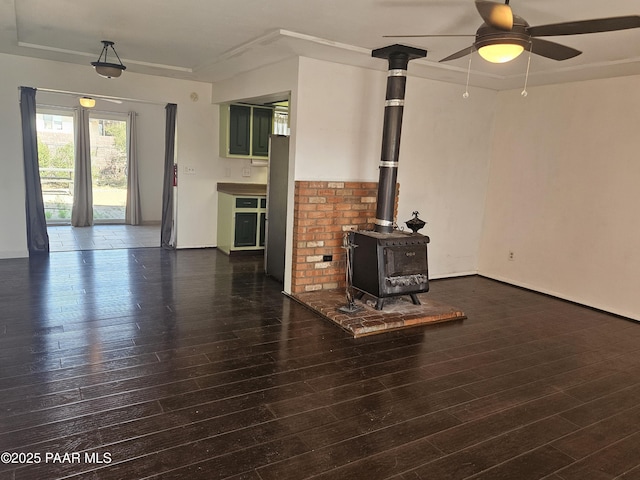 3916 N Catherine Dr, Prescott Valley, AZ 86314 - unfurnished living room featuring a wood stove, ceiling fan, and dark wood finished floors