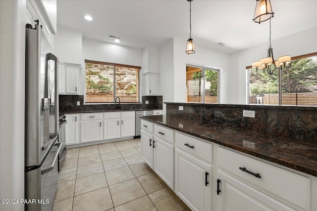 kitchen with a healthy amount of sunlight, white cabinetry, and stainless steel appliances