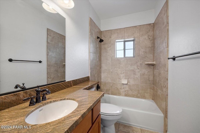 full bathroom with tile patterned floors, vanity, tiled shower / bath combo, and toilet