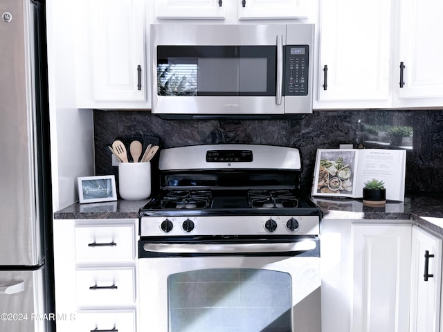 kitchen with decorative backsplash, stainless steel appliances, and white cabinetry