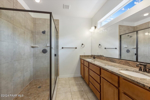 bathroom featuring tile patterned flooring, vanity, and an enclosed shower