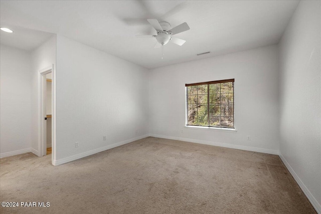 empty room with ceiling fan and light colored carpet