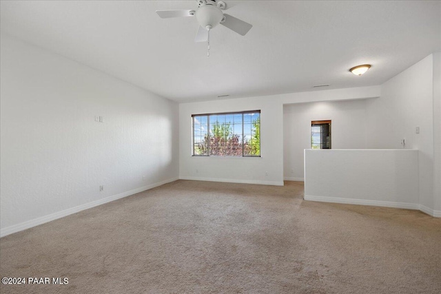 empty room featuring light colored carpet and ceiling fan