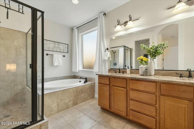 bathroom with tile patterned flooring, vanity, and independent shower and bath