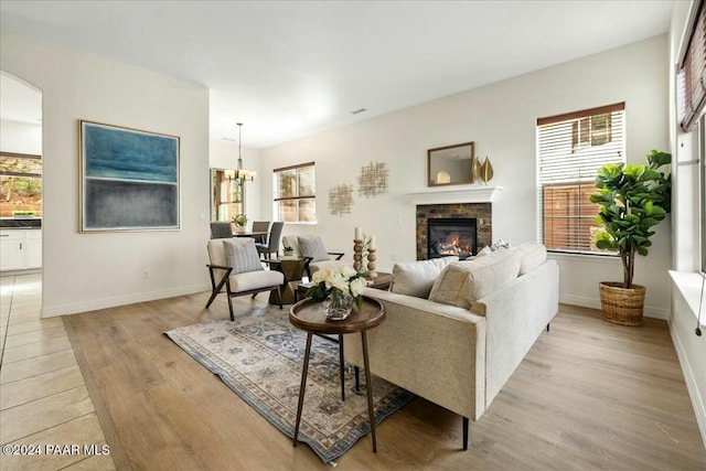 living room featuring light wood-type flooring and a chandelier