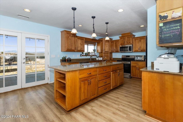 1525 Salida Del Sol, Chino Valley, AZ 86323 - kitchen with stainless steel appliances, light wood-type flooring, brown cabinetry, open shelves, and recessed lighting