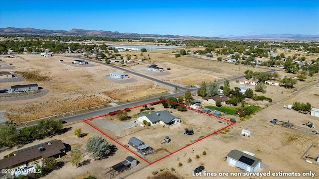 1525 Salida Del Sol, Chino Valley, AZ 86323 - aerial view of property and surrounding area featuring mountains, property boundaries highlighted, and a desert landscape