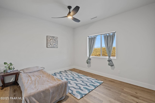 living area featuring ceiling fan and light hardwood / wood-style floors