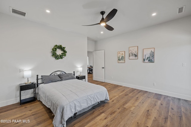 bedroom with ceiling fan and hardwood / wood-style floors