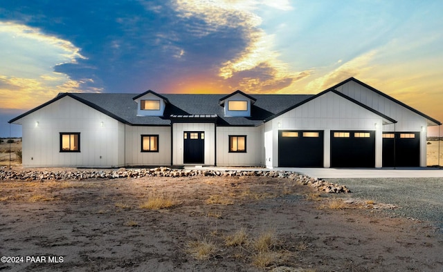 modern inspired farmhouse with a garage